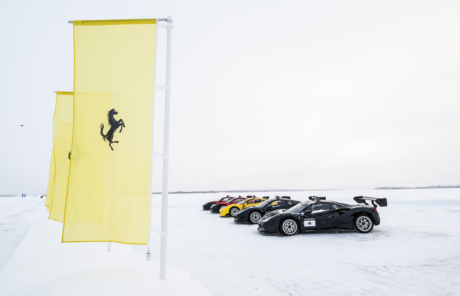 Ferraris lined up on an ice racing track