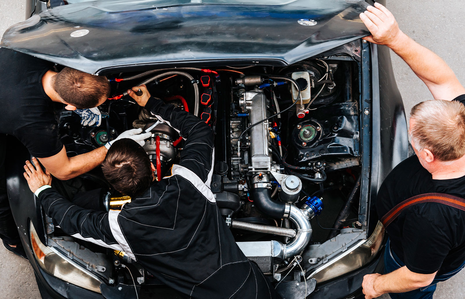 mechanics check the car engine before driving.